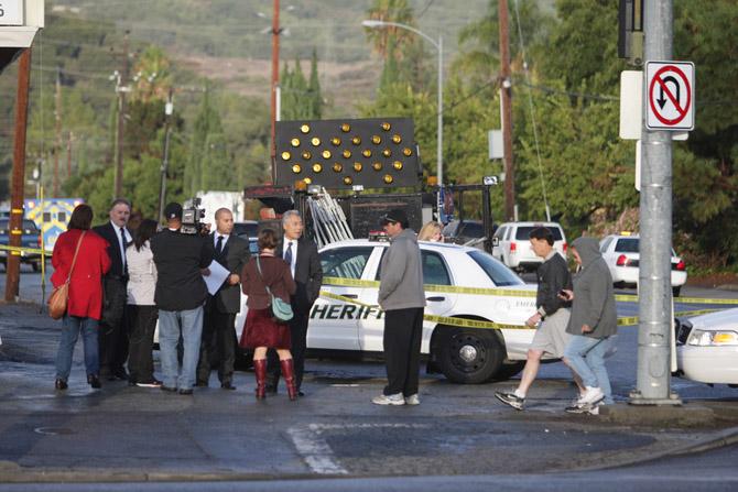Police officials, media and family members of those working at Lehigh Cement Factory converge on the intersection of Foothill Blvd. and Stevens Creek Blvd. at approximately 8 a.m. after suspect Shareef Allman killed two workers and wounded six. Photo by Kevin Tsukii.