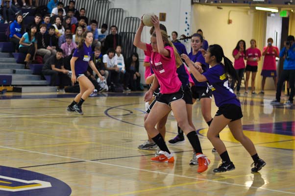 Senior Hitomi Sugimoto attempts to take the ball away from freshman Hannah Pollek during the 2012 vs. 2015 Powderpuff game. The seniors won the game 4-0. Photo by Elvin Wong.