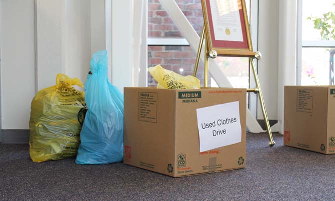 Clothing donations lie in the office’s box for the clothes drive organized by Interact and FBLA. Donations will be given to Seventh Generation Recycling, a local company that distributes and recycles new and used clothing. Photo by Carissa Chan.