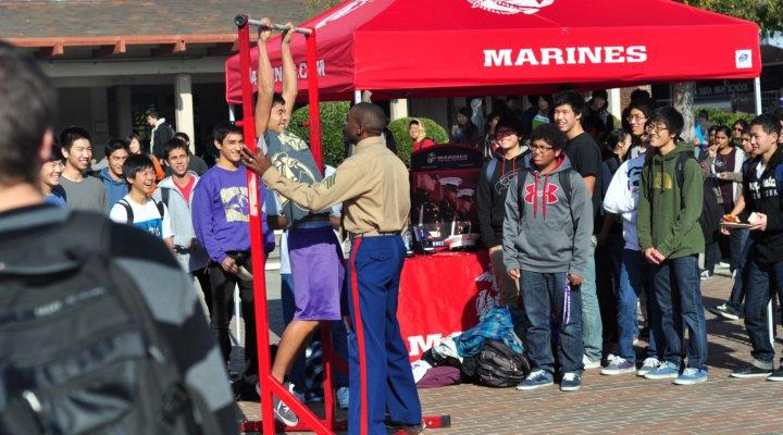 Sophomore Takuto Doshiro takes part in the annual pull-up challenge at lunch on Dec. 8 hosted by the Marine Corps for publicity purposes. Several students crowded around in the Rally Court to watch friends earn prizes for participating in the event. Photo by Kevin Tsukii. 
