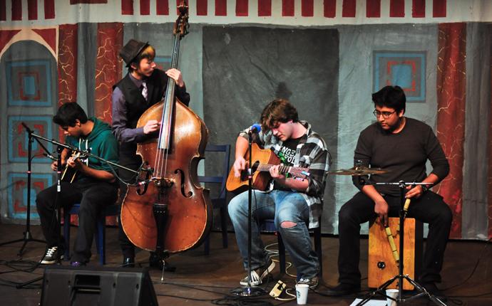 From left to right: junior Kieren Patel, seniors Wells Lucas Santo and Max Sorg, and junior Adi Nag, members of the local band Seventh Day Breakdown, perform an acoustic set at La Pluma’s Coffee House on Jan. 20. According to organizer senior Sokena Zaidi, the Coffee House was created as a night of great performances to promote the literary magazine. Photo by Elvin Wong.