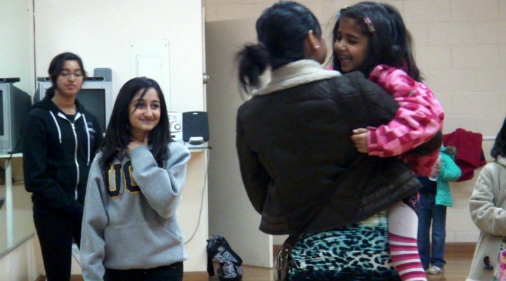 One of the 17 students, aged 5 to 8 years old, laughs with her mother as they talk to junior Anu Varshneya. Varshneya eaches Bollywood dance in a small dance studio on De Anza Boulevard. Photo by Karishma Mehrotra.