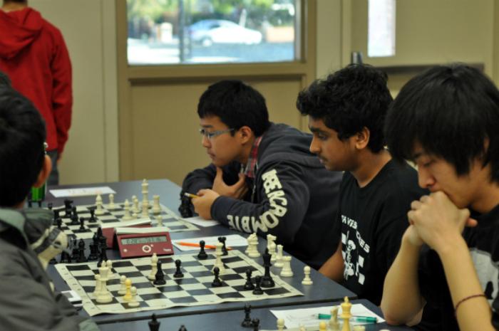Chess Club member junior Siddarth Manoj plays against his opponent during the first round of the chess tournament. The chess tournament was held Feb. 4 from 8 a.m. to 7 p.m. Photo by Margaret Lin.