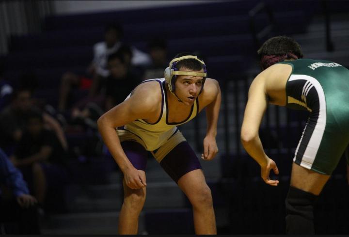 Sophomore Faris Karaborni faces off with his Homestead opponent. After a a tough fight, Karaborni prevails, bringing the score up three points. Photo by Kevin Tsukii 