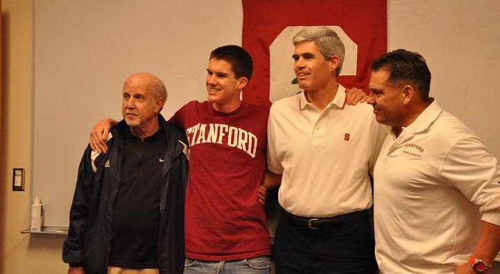 Senior Kevin Bishop stands with his father, Cary Bishop, and his coaches, Mike Dudley (far right)  and Willy Harmatz (far left). Kevin Bishop signed a contract to run for Stanford University’s Cross Country team starting next fall in a small ceremony at the conference room of the office. Photo by Margaret Lin.