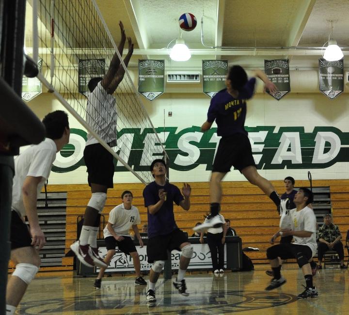 Junior Cory Low takes a powerful swing past Homestead blockers as teammates seniors Jeffrey Zhang and Edward Wang look on. Though the Matadors won the first set, they lost the game 3-1. Photo by Cynthia Mao.
