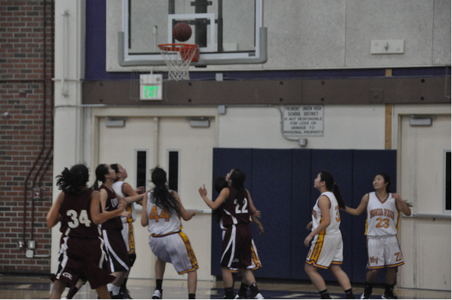 The Lady Mats eagerly anticipate the ball falling into the hoop shot from the three-point line. Photo by Athira Penghat.