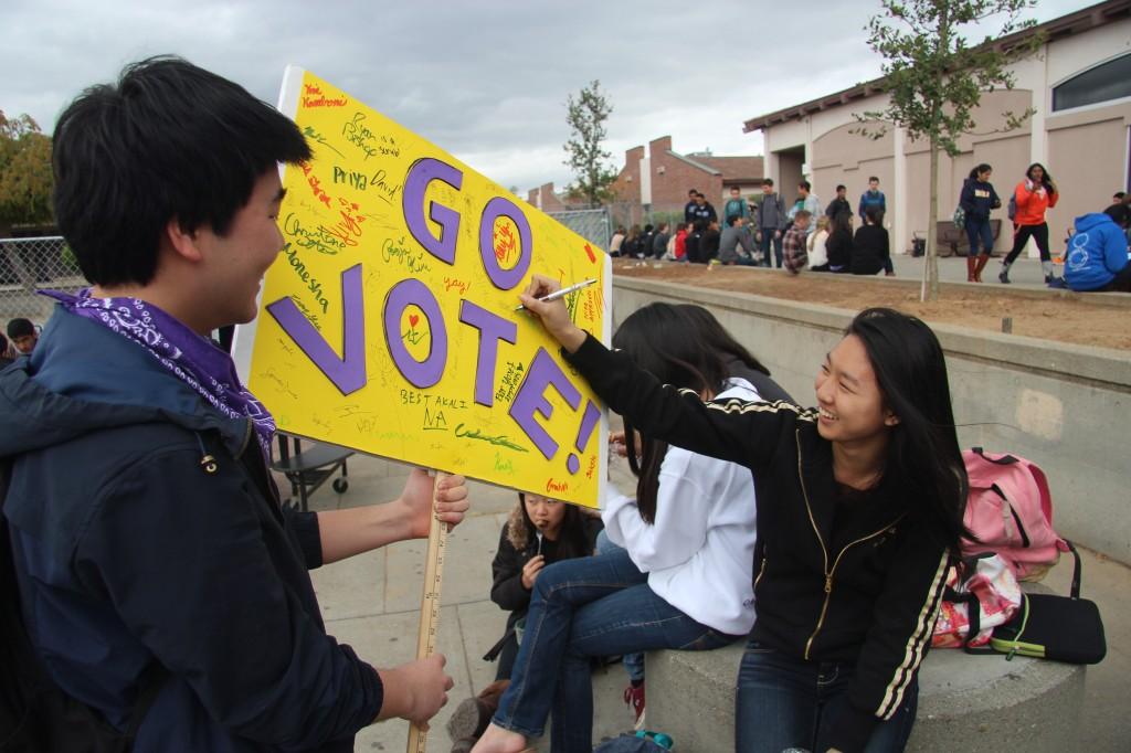 Junior Colin Kim allows students to sign his campaign poster. After three days of campaigning, ASB officers were announced on March 21. Photo by Mihir Joshi.