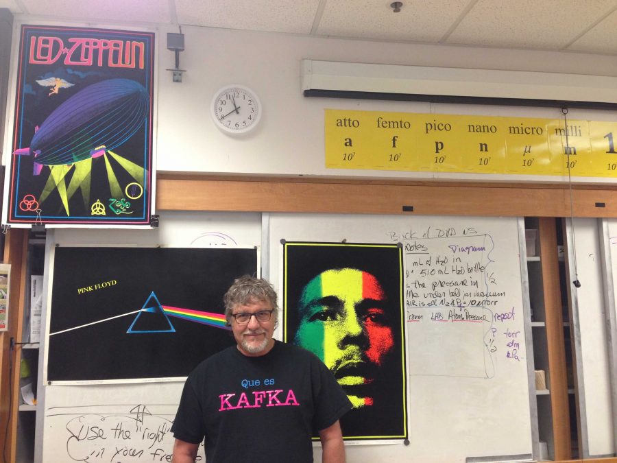 McCrystal stands in front of his posters, which depict Bob Marley, Led Zeppelin and Pink Floyd, some non-bands he listens to along with jazz. Photo by Joyce Varma.
