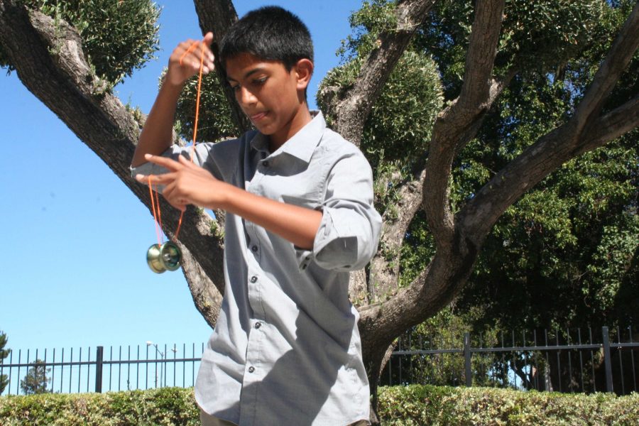Shaik who recently began learning yo-yo tricks demonstrates a beginner trick. Photo by Catherine Lockwood.