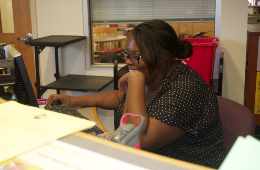 Monique Balentine sits at the desk where she coordinates the Study Buddies Society program. She organizes student tutors so that struggling students can be helped. Photograph by Tanisha Dasmunshi