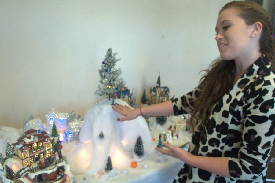 Sophomore Michaela Murphy exhibits her handiwork in the front lobby. Murphy and her Advanced Drama classmates crafted a miniature 3D diorama of the town of Almost, Maine. Photo by Yashashree Pisolkar.