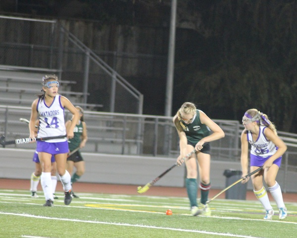 Senior Amelia Strom attempts to steal the ball from a Homestead High School opponent, while senior Sarah Im gets into a good position to assist her. The field hockey team defeated Homestead 5-0 in their senior game on Nov. 7. Photo by Mihir Joshi.