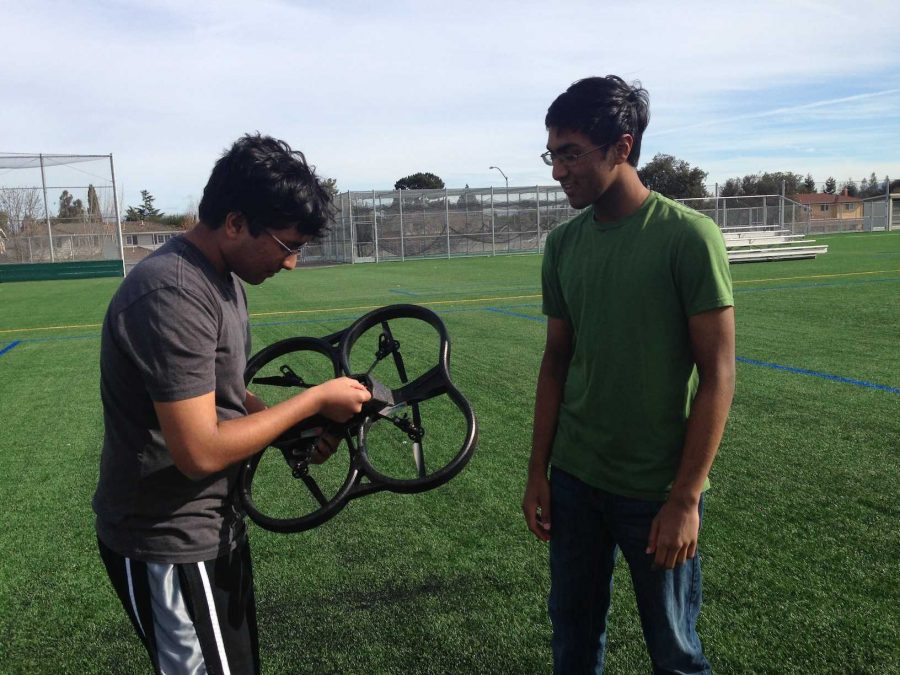 Senior Paras Jain and sophomore Ajay Jain, respectively the club’s President and Vice President, look at the quadrotor helicopter, which they displayed at the club’s meeting on Jan. 28. A quadcopter is a multirotor device propelled by four rotors. Photo by Varsha Venkat.