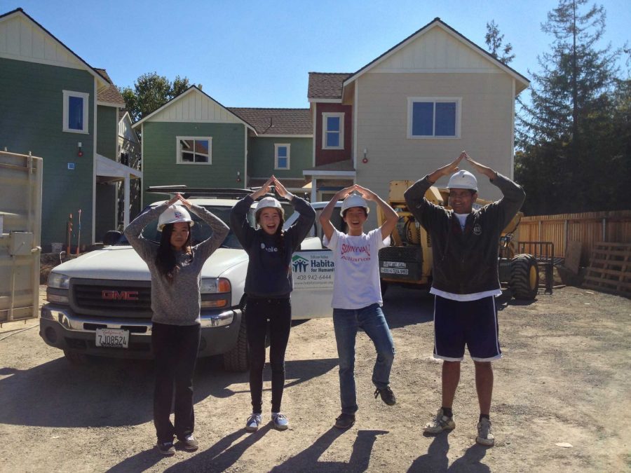 Co-presidents senior David Chang and junior Sydney Howard strike a signature Habitat for Humanity pose during a build in 2012 with alumni Alaina Lui and Atharva Fulay. Photo used with permission of David Chang.
