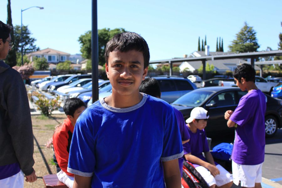 Freshman Rohan Jain meets with his fellow teammates at the entrance to the tennis courts on March 27. Jain is one of the seven freshman to make it on the team this year. Photo by Brian Fan.
