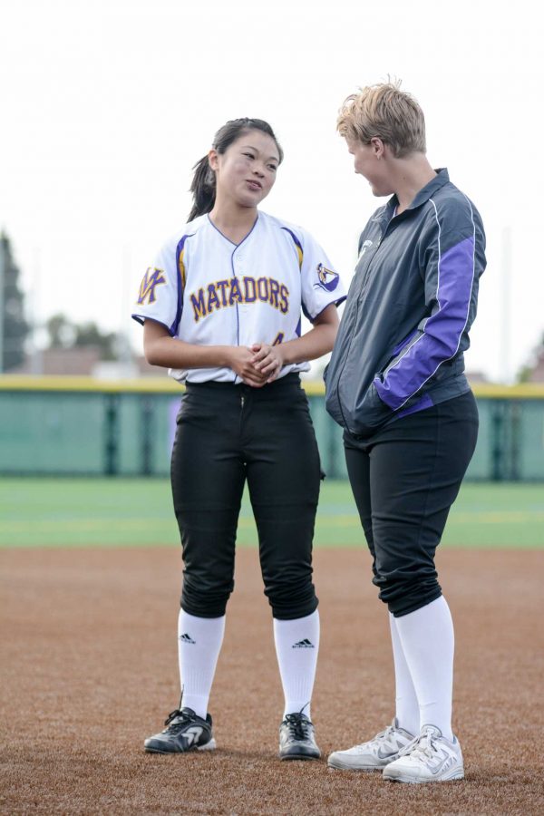 Mika Maenaga (left) recounts the ways the Senior Emily Simmons (right) has helped her grow as a player. Simmons is the catcher for the team.