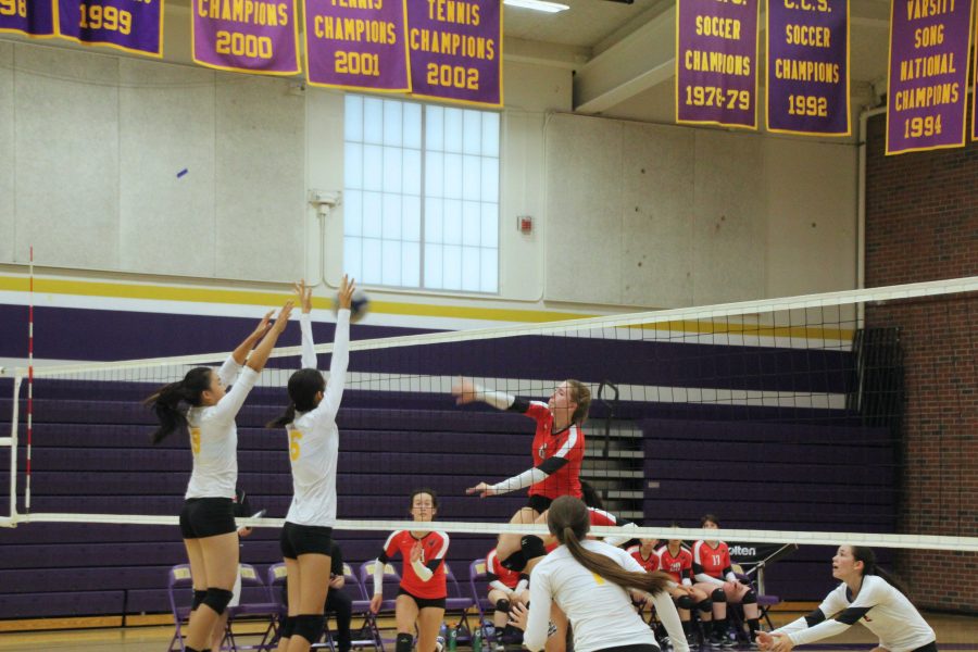 Junior Amanda Hua and freshman Phoebe Li go up for the middle block. In this first set, the team came out strong and swept 25-17. Photo by Aditya Pimplaskar