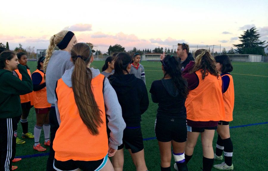 During a scrimmage on Nov. 24, the team huddles up to discuss a potential game tactic. Coach DJ Driscoll had the girls work together on better formations so they would be ready for any situation during a game. Photo by Akshara Majjiga