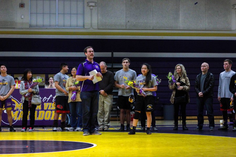 All the seniors line up on the wrestling mat after the JV matches. Senior night gave recognition to the seniors. Photo by Vanessa Qin.