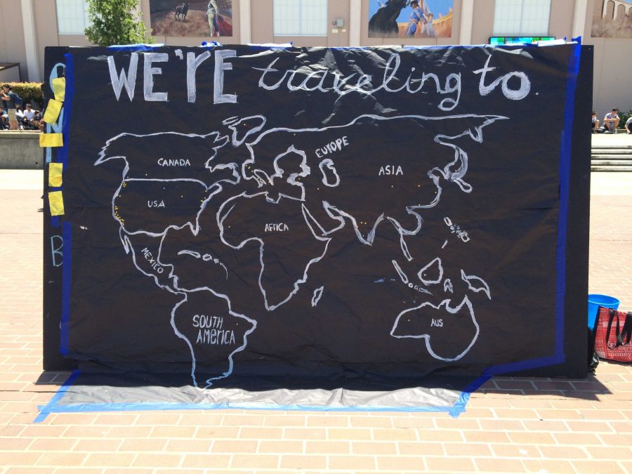 The blackboard in the rally court with a map drawn on it. Students could stick the gold star-shaped stickers taped onto the left side of the board onto the board to represent where they will be spending their 2016 summer.