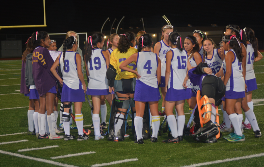 The players gather in a huddle after the game. Despite the results, they felt they played well as a team.