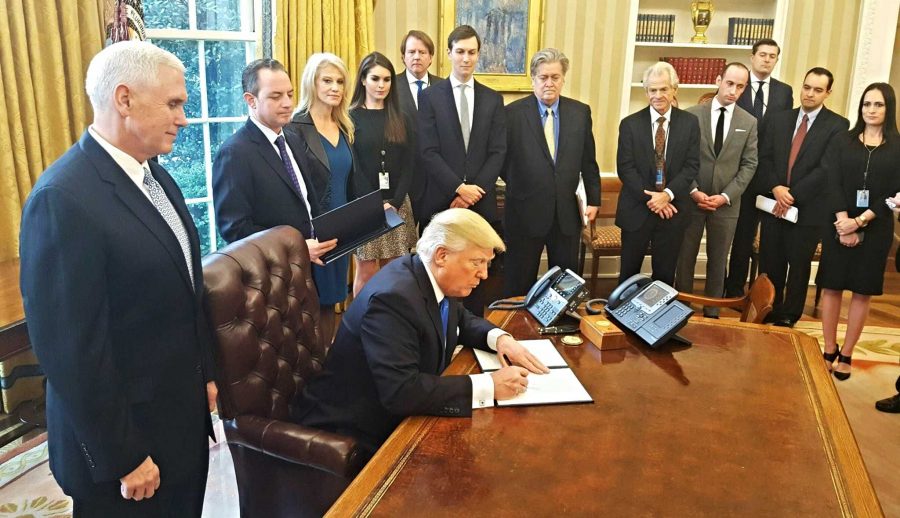 President Donald Trump signs ten new executive orders after Jan. 25. He signs the order to move forward with the Keystone XL and Dakota Access Pipelines. Photo taken from Creative Commons by Karl-Ludwig Poggemann