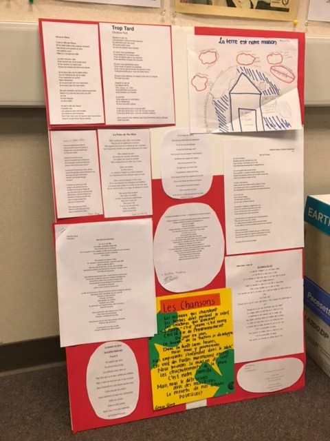 French 4 Honors students poems hang on a poster in French teacher Sarah Fincks classroom. Finck had her students write poems to submit to one of two competitions. 