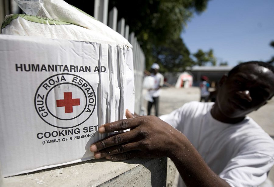 100125-N-6266K-238
PORT-AU-PRINCE, Haiti (Jan. 25, 2010) A Red Cross worker picks up a humanitarian box to give to an earthquake survivor in Port-au-Prince. Haiti experienced a 7.0 magnitude earthquake on Jan. 12, 2010, that devastated much of the island nation. (U.S. Navy photo by Mass Communication Specialist 1st Class Joshua Lee Kelsey/Released)