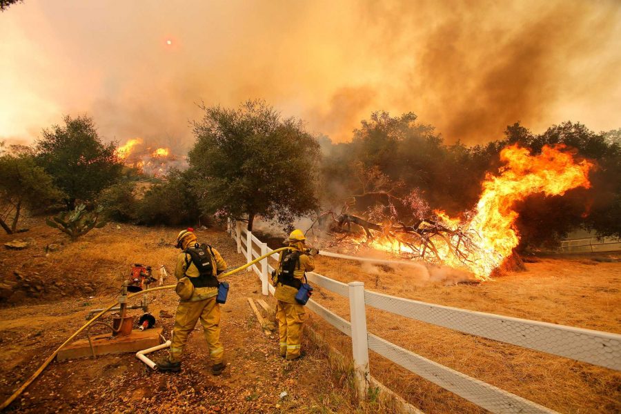 Ffirefighters from Stockton, Calif.,  put out flames off of Hidden Valley Rd. while fighting a wildfire, Friday, May 3, 2013 in Hidden Valley, Calif. A huge Southern California wildfire burned through coastal wilderness to the beach on Friday then stormed back through canyons toward inland neighborhoods when winds reversed direction. (AP Photo/Los Angeles Times, Mel Melcon)  NO FORNS; NO SALES; MAGS OUT; ORANGE COUNTY REGISTER OUT; LOS ANGELES DAILY NEWS OUT; VENTURA COUNTY STAR OUT; INLAND VALLEY DAILY BULLETIN OUT; MANDATORY CREDIT, TV OUT