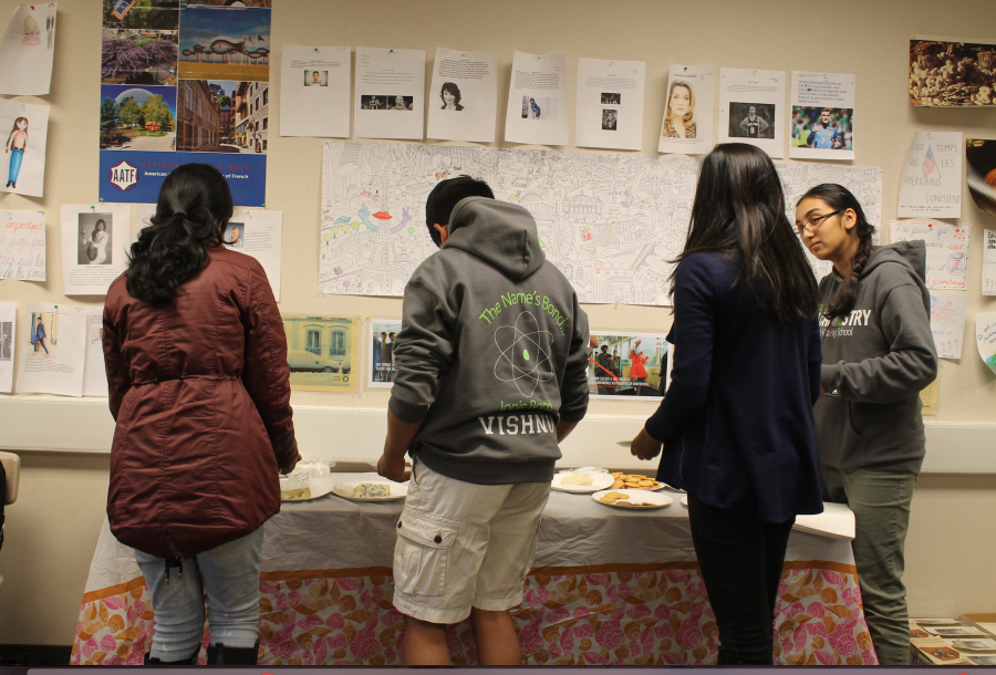 Ramachandran and other emebrs of the French Honor Society sample traditional food while socializing. Photo by Amanda Chen