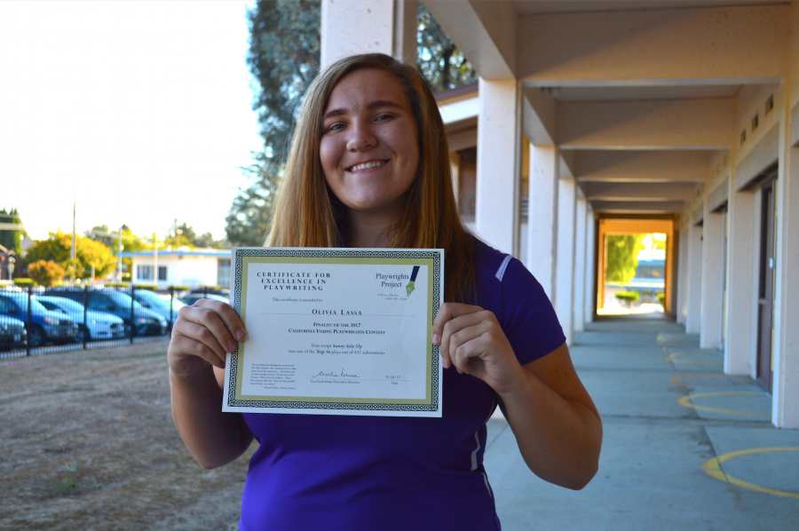 Senior Olivia Lassa holds up her certificate as a finalist in the California Young Playwrights Project. Lassa was one of 17 students recognized by the organization. Photo by Akshara Majjiga.