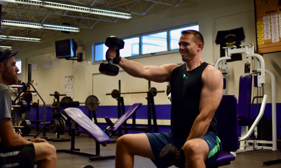 Guidance counselor Clay Stivers performs forward raises in the MVHS weight room. Stiver opens up the room from 4 to 6pm on Mondays and Wednesdays. Photo by Om Khandekar.