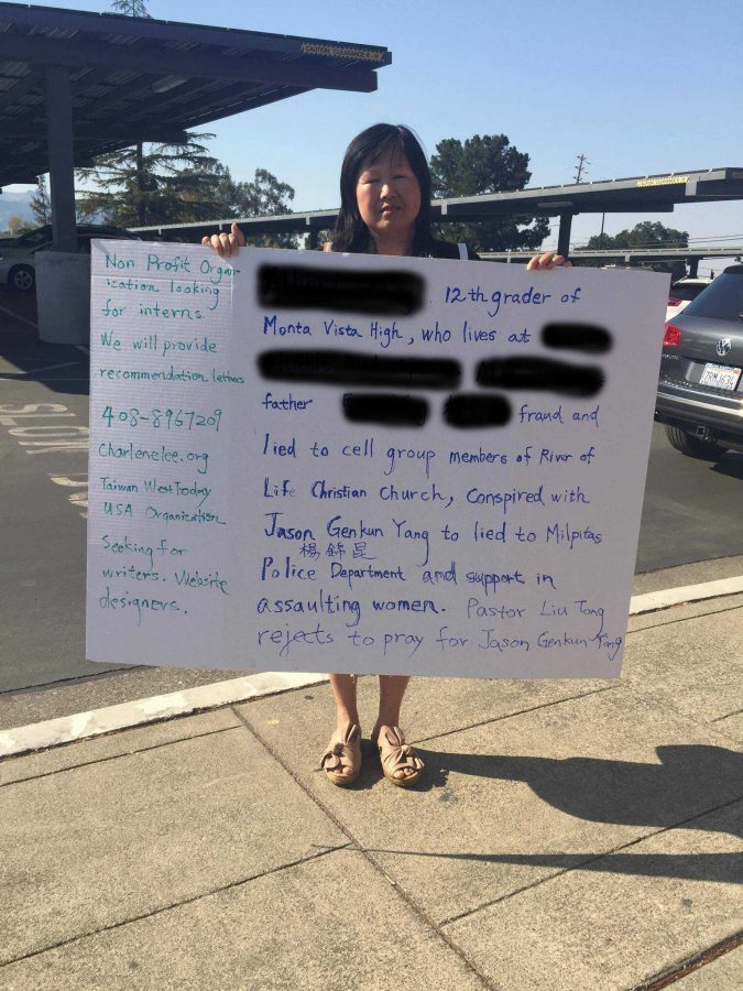 Woman with poster makes accusations against student’s father