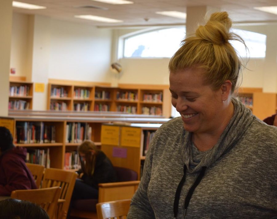 History teacher Bonnie Belshe chats with her students