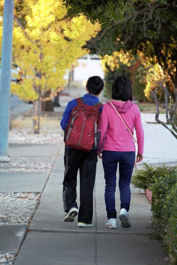 Wendy Wang walks her younger son to school in the morning.