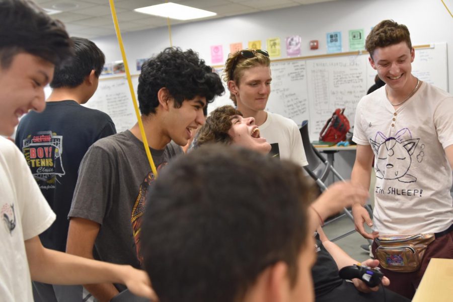 Senior Ethan Christian, juniors Yash Karandikar, Harry Neil and Dylan Frei and senior Bryce Nevitt (from left to right) share a laugh over a game of Smash.