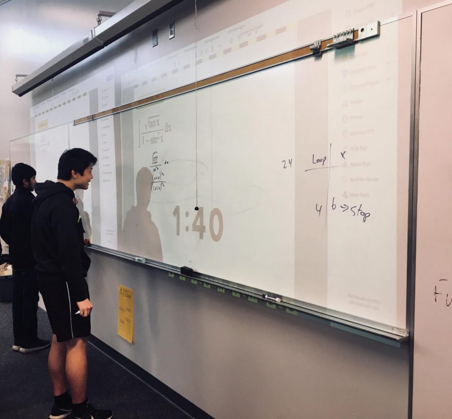 Sophomore Suraj Mathashery and Junior Jacob Nie go head to head in the final round of the integration bee. Photo by Iman Malik.