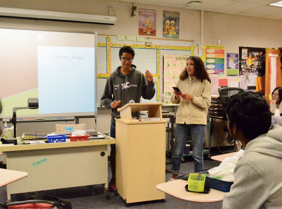 Sophomores Claudia Maldonado and Siddhant Patel present their argument to the rest of the Spanish Honors Society. Photo by Brandon Ng.