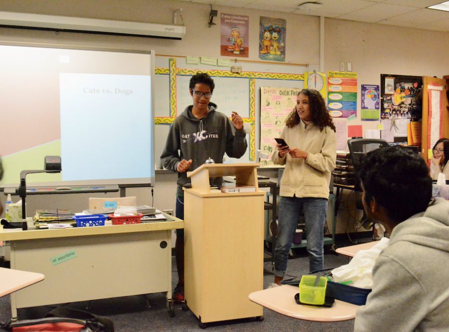 Sophomores+Claudia+Maldonado+and+Siddhant+Patel+present+their+argument+to+the+rest+of+the+Spanish+Honors+Society.+Photo+by+Brandon+Ng.