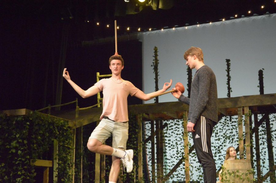 The princes (played by senior Bryce Nevitt and junior Antoni Kalkowski) joke around on stage, performing silly tricks with the plungers during their dress rehearsal.