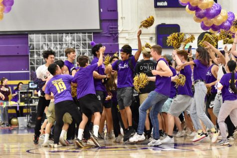 Senior Sujay Bhatt jumps in the air after hearing that the class of 2019 won. After the results were announced, the 2019 ran from the bleachers into the middle of the gym to celebrate. Photo by Anish Vasudevan.