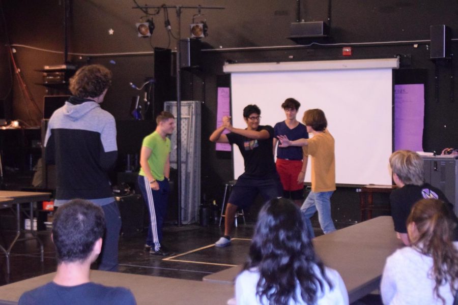 Members make up a dramatic fight scene on the spot in a certain film style for another improv activity called “Styles Replay.” Photo by Vivian Jiang