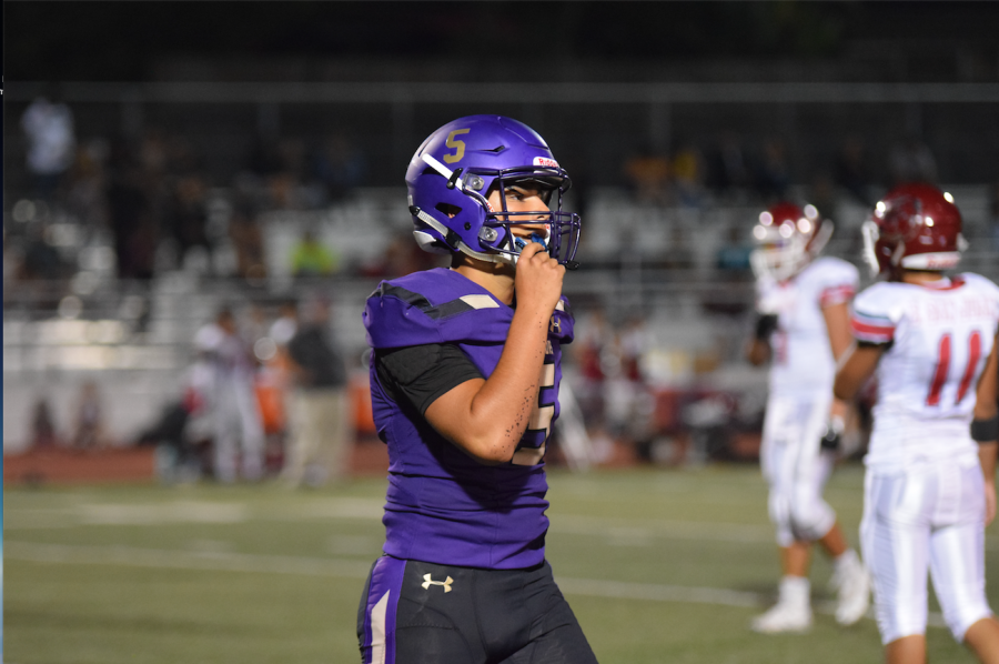 Junior and quarterback Simon Loeffler heads off the field. Photo by Tabitha Mendez