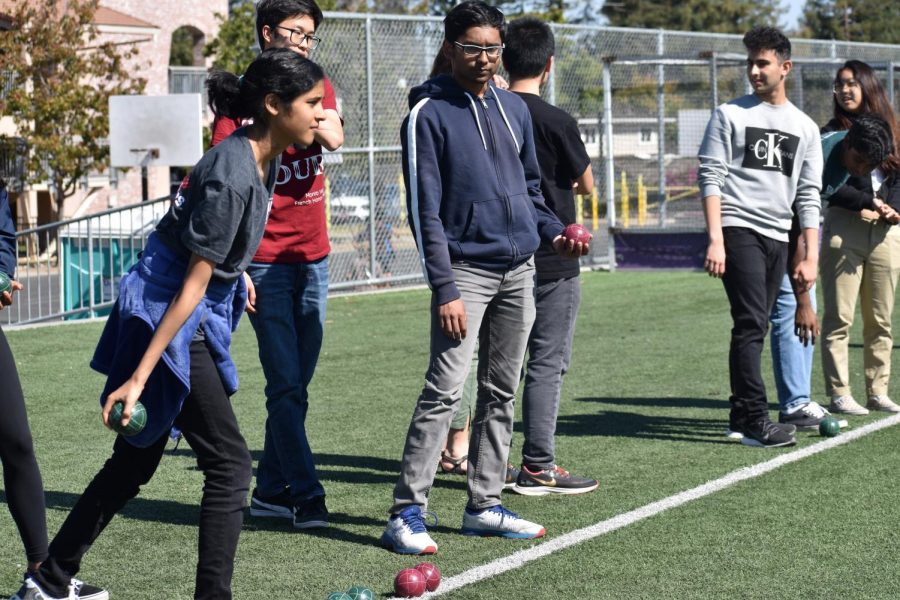 In Petanque players remain in a small circle while doing their throw, in this case French Honors Society club members played from behind a white line. Photo by Sarah Young.