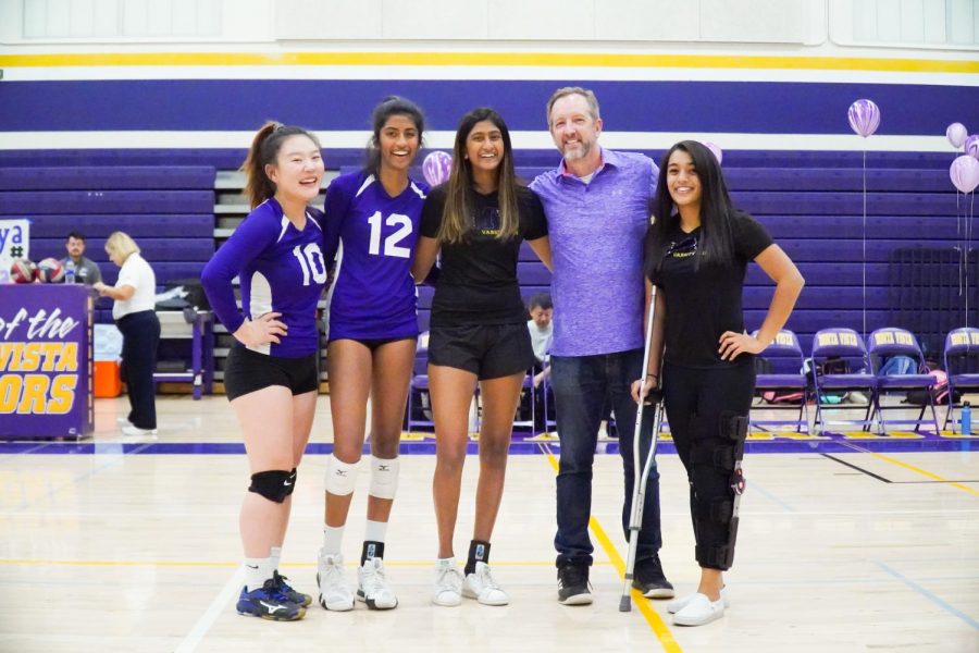 All+the+seniors+apart+of+the+girls+varsity+volleyball+team+and+coach+Colin+Anderson+pose+for+a+photo+after+the+senior+night+game.