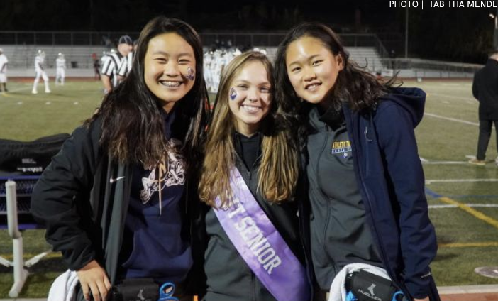 From left to right, junior Allison Leung, senior Hannah Risher and  junior Hannah Ho pose together at the football game against Homestead. Photo by Tabitha Mendez