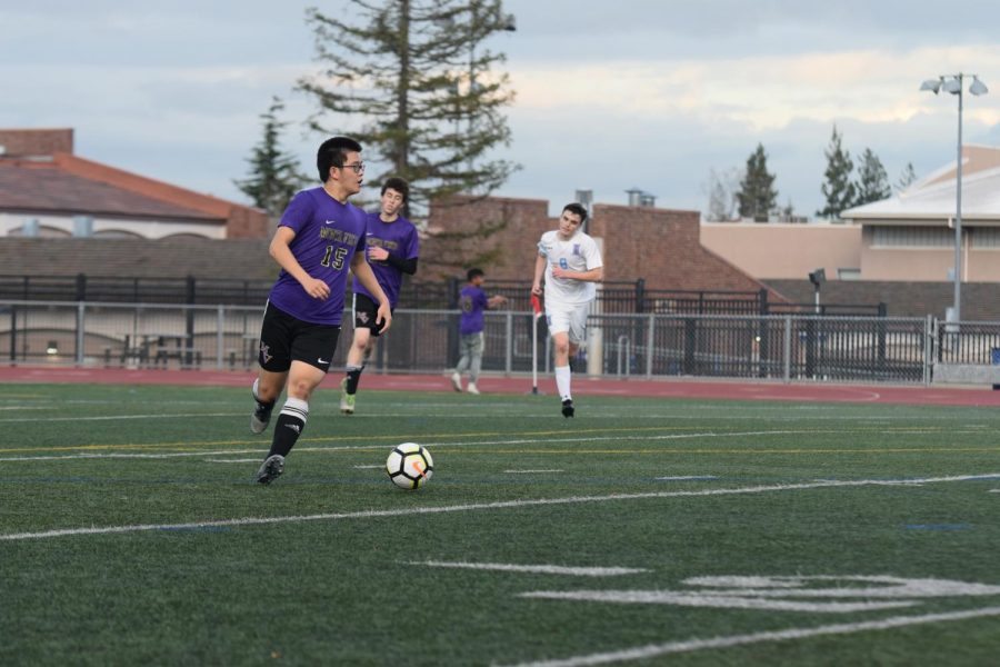 Junior Frank Liu looks up the field to try and pass the ball.