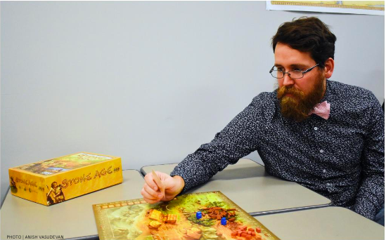History teacher David Hartford playing the board game Stone Age in his classroom. Hartford tries to incorporate board games into his classroom when possible. 