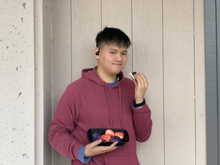  Senior Ethan Hu poses with one of the five boxes of macarons he brought to school on Nov. 6. 